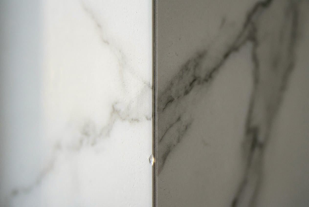 Mitered corner seam on a marble slab wall